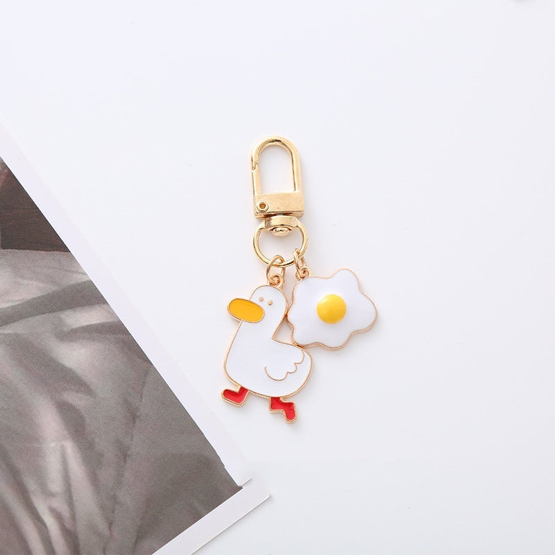 Quirky Charm: Pineapple Fried Egg Duck Metal Car Key Ring ($\mathbf{5.9\text{g}}$).