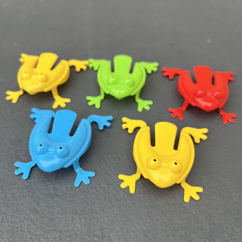 Simple Fun: Children's Classic Pressing Little Jumping Frog Decompression Toy.