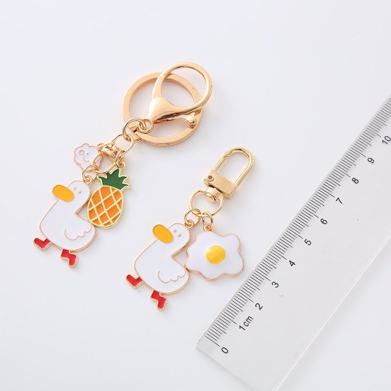 Quirky Charm: Pineapple Fried Egg Duck Metal Car Key Ring ($\mathbf{5.9\text{g}}$).