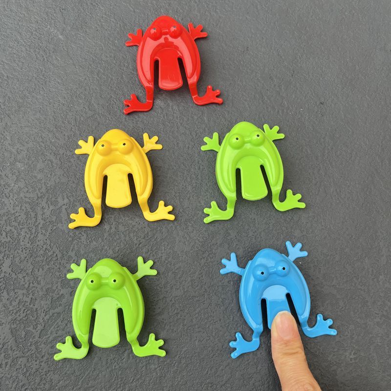 Simple Fun: Children's Classic Pressing Little Jumping Frog Decompression Toy.