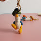 Cozy Companion: Hand-Woven Forward Duck Little Doll Keychain (Wool, Cartoon Style).