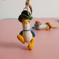 Cozy Companion: Hand-Woven Forward Duck Little Doll Keychain (Wool, Cartoon Style).