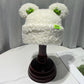 Cozy Fun: Japanese Cartoon Cute Frog Lambswool Bun Head Hat (Warm & Age-Defying).