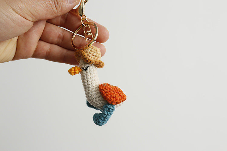 Cozy Companion: Hand-Woven Forward Duck Little Doll Keychain (Wool, Cartoon Style).