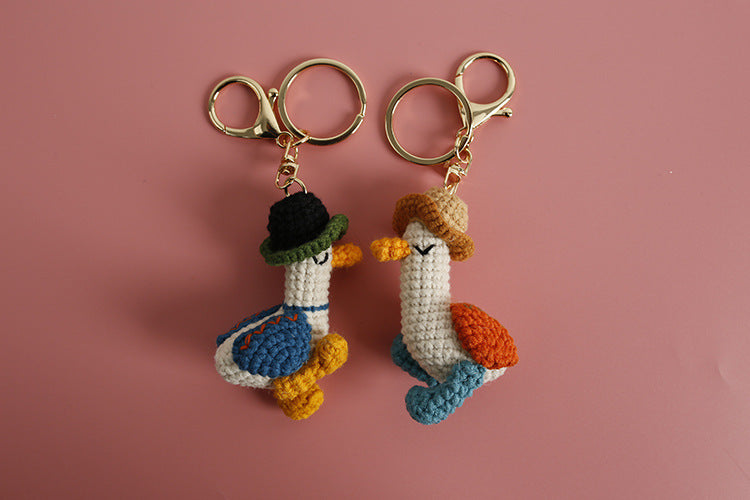 Cozy Companion: Hand-Woven Forward Duck Little Doll Keychain (Wool, Cartoon Style).